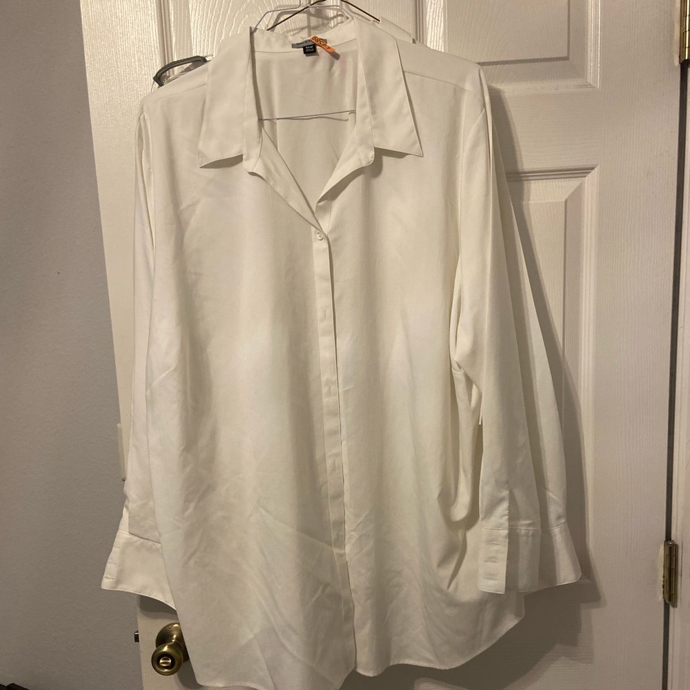 Two women’s white button up shirts